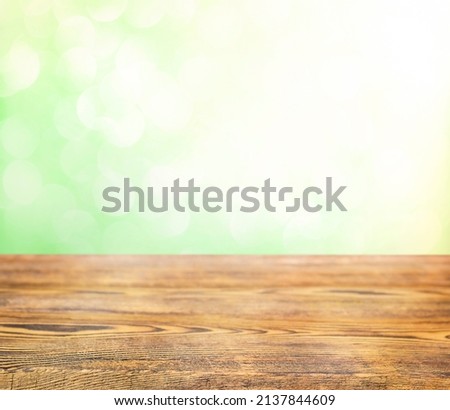 Mixed background. Wooden surface on a green background. bokeh
