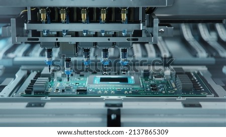 Automatic Pick and Place machine quickly installs Components on Generic Circuit Board. Electronics and Circuit board Manufacturing. Bright Environment Royalty-Free Stock Photo #2137865309