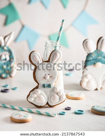 Easter card with pastel color funny Easter rabbits and bunny of gingerbread cookies. gingerbread bunny with bottle of milk