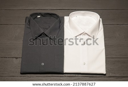 Classic white and dark shirt with long sleeves on a dark background