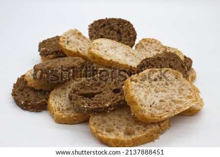 top view of whole grain multigrain bread slices contain whole grains (poppy, millet, flaxseed, pumpkin seeds and sunflower seeds) isolated on white background