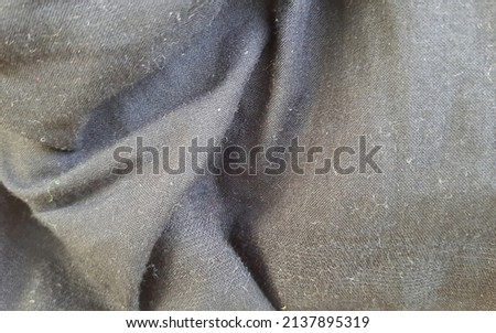 faded and wrinkled black cloth surface