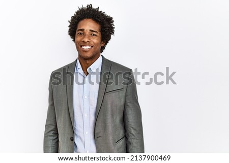 Young african american man wearing business jacket over isolated white background looking positive and happy standing and smiling with a confident smile showing teeth 