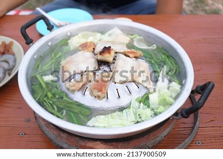 Thai barbecue Grill Pork on hot pan, Thai style BBQ and vegetables soup, Moo Kra Ta Royalty-Free Stock Photo #2137900509