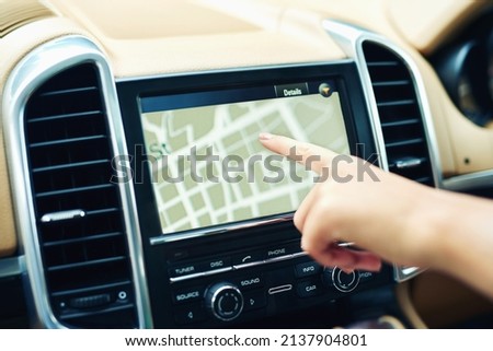 Finding locations the efficient and easy way. Shot of an unrecognizable woman using a gps in a car.