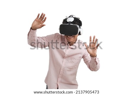 Young peruvian man laughing using virtual reality headset. Isolated over white background.