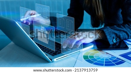 Businesswoman hands working on laptop computer with documentation database manage files virtual screen, Business system and financial planning concept. 