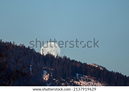 moonset at the sunrise in the mountains  