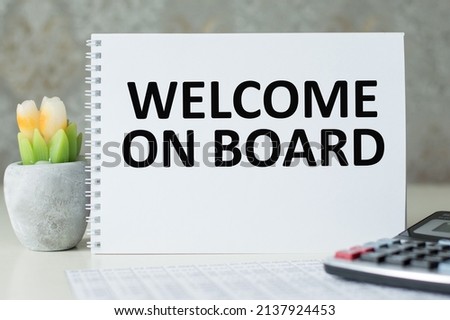 Welcome on board inscription on the notebook on the table, business concept