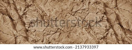 Light brown rock texture. Mountain rough surface. Close-up. Stone wall background with copy space for design. Wide banner. Panoramic. Royalty-Free Stock Photo #2137933397
