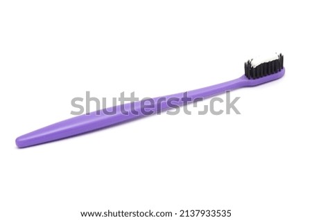 purple toothbrush with toothpaste isolated on white background.