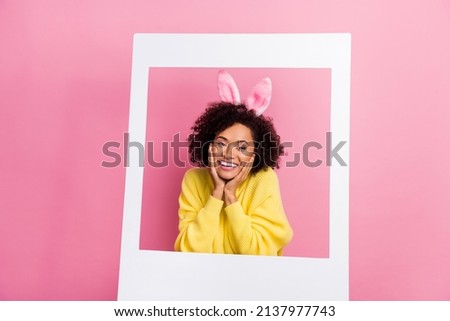 Photo of funny dreamy lady wear yellow sweater easter headband arms cheeks tacking photo isolated pink color background