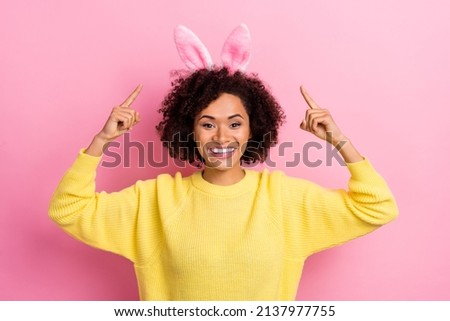 Photo of sweet pretty woman dressed kitted pullover easter headband pointing up empty space isolated pink color background