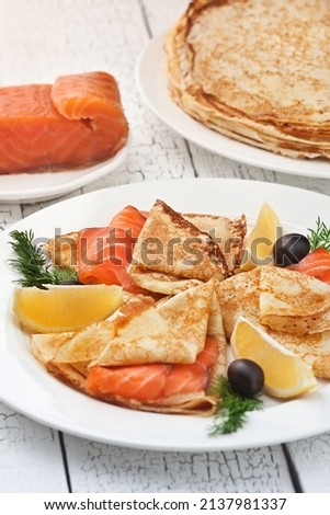 Pancakes with red fish. Photo of food on a light background
