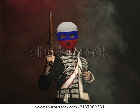 Duel challenge. Duel challenge. Young men, art character in vintage outfit and balaclava on dark background. Concept of comparison of eras. Stop war conflict, crisis. Creative collage. Flyer Royalty-Free Stock Photo #2137982331