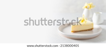 New York cheesecake or classic vanilla cheesecake banner. Delicious cheesecake with vanilla flower on a white stone background. Copy space. Confectionery web line, promotion Royalty-Free Stock Photo #2138000405