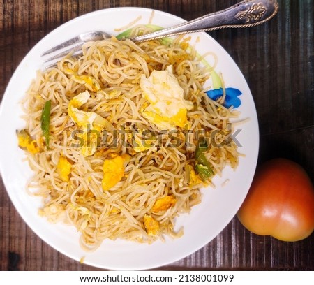 Egg noodles with spicy and peppers tomatoes wooden background stock photo