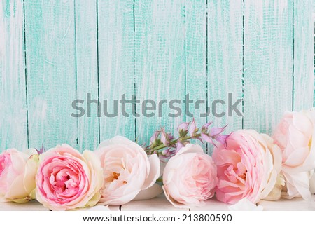 Fresh roses on  wooden background. Place for text.