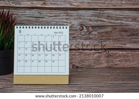 White September 2022 calendar on wooden desk. 2022 new year concept. Copy space.