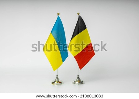 State flags of Ukraine and Belgium on a light background.