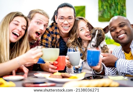 Happy friends taking selfie at hotel lobby with cute dog drinking coffee - Young people having fun together at fashion cafeteria - Life style concept with happy men and women at cafe - Vivid filter  Royalty-Free Stock Photo #2138036271