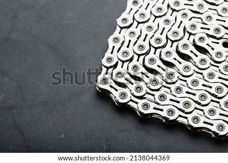 Shiny mountain bike chain on dark background with free space