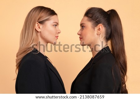 Two business woman facing each other face to face eyes to eyes friends business competition with partner concept. 2 caucasian female business person looking each other in face. Coworker confrontation Royalty-Free Stock Photo #2138087659