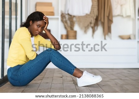 Depression. Depressed Black Woman Sitting In Her Room Expressing Sadness Feeling Lonely And Unhappy Looking At Camera At Home. Full Length Shot Of Frustrated Millennial Lady. Loneliness Concept Royalty-Free Stock Photo #2138088365