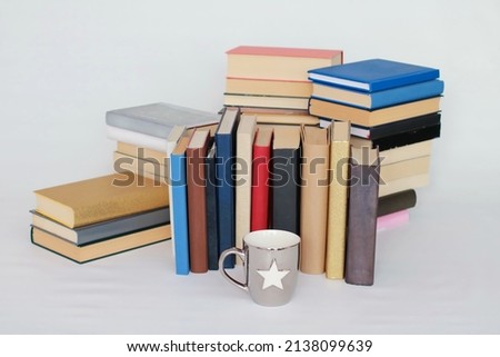 Books and a cup of tea on a white background