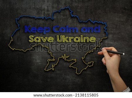 girl draws a map of Ukraine with the text keep calm and save Ukraine on the blackboard