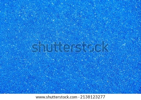 Healthy sports concept, detail of the texture of a blue artificial grass paddle tennis court
