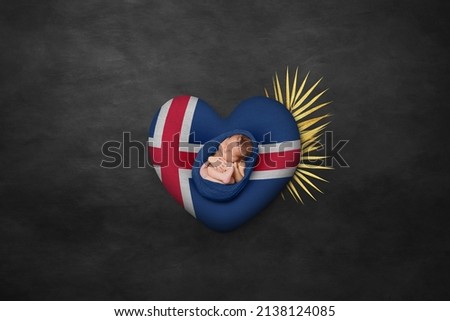 Newborn portrait on heart in color of national flag. Photography peace concept. Iceland