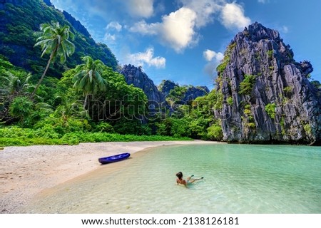 Girl at Hidden Beach in Matinloc Island, El Nido, Palawan, Philippines - Tour C route - Paradise lagoon and beach in tropical scenery Royalty-Free Stock Photo #2138126181