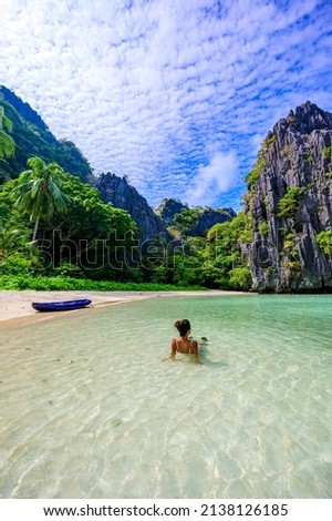 Girl at Hidden Beach in Matinloc Island, El Nido, Palawan, Philippines - Tour C route - Paradise lagoon and beach in tropical scenery Royalty-Free Stock Photo #2138126185