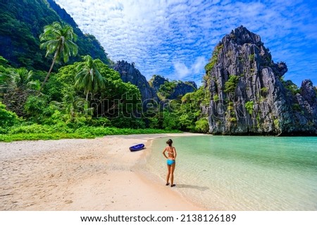 Girl at Hidden Beach in Matinloc Island, El Nido, Palawan, Philippines - Tour C route - Paradise lagoon and beach in tropical scenery Royalty-Free Stock Photo #2138126189