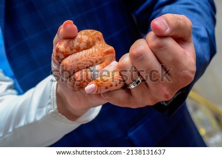 Picture of man and woman with wedding ring.Young married couple holding hands, ceremony wedding day. Newly wed couple's hands with wedding rings.
