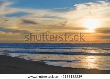 Sunset on the beach, beautiful cloudy sky background