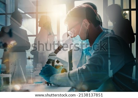 Doctor in the laboratory analyzes samples of codiv-9 under a microscope