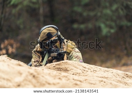 Alarmed sly veteran soldier protecting border tirelessly . High quality photo
