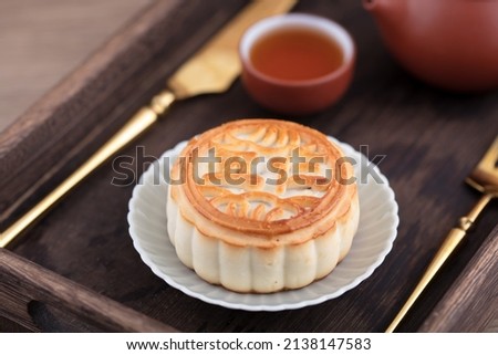 Moon cakes and tea for the Chinese Mid-Autumn Festival.The Chinese characters in the picture mean "five kinds of dried nuts"