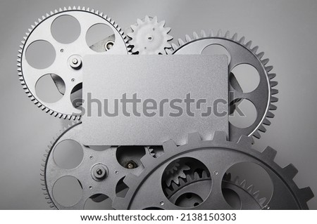 card and gear wheel on a gray background.