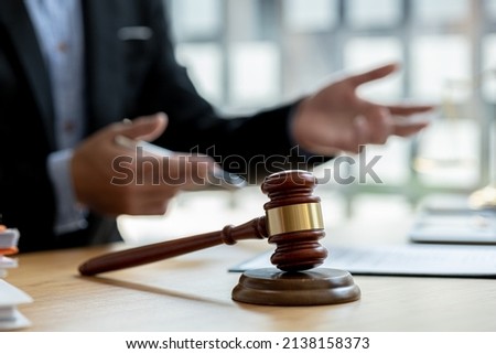 The judge's hammer is placed on the table, the lawyer concept assumes that the defendant defends the client in order to win the case or gain the greatest benefit in accordance with the law. Royalty-Free Stock Photo #2138158373