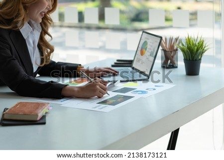 Businesswoman doing finance and calculate about cost to investment , business Financing Accounting Banking Concept, tax system