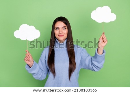 Photo of cute young brunette lady look clouds wear blue turtleneck isolated on green color background