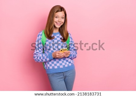 Photo of blond nice small girl hold telephone wear backpack pullover isolated on pink color background