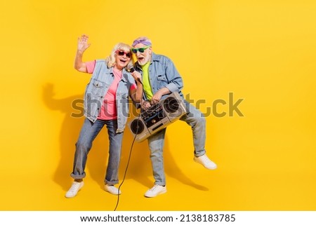 Photo of charming sweet girlfriend boyfriend dressed denim outfit listening boom box singing isolated yellow color background