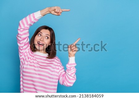 Photo of impressed millennial lady index promo wear striped shirt isolated on blue color background