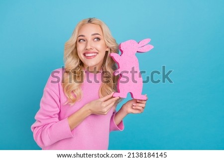 Photo of funky millennial curly blond lady hold bunny wear pink jumper isolated on blue color background