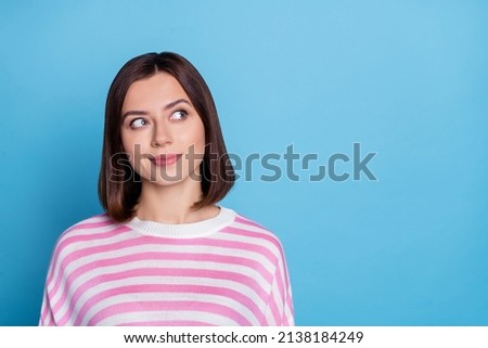 Photo of charming dreamy young lady dressed pink pullover looking empty space isolated blue color background