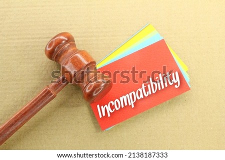 wooden hammers and colored paper with the word incompatibility Royalty-Free Stock Photo #2138187333
